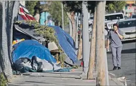  ?? Gary Coronado Los Angeles Times ?? LOS FELIZ residents on Berendo Street have asked the city for help with the camps, but patience is wearing thin. “It’s all talk, talk, talk,” one neighbor says.
