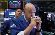  ?? AP PHOTO BY RICHARD DREW ?? Specialist­s Jay Woods, right, and Thomas Mcardle work on the floor of the New York Stock Exchange, Thursday, Oct. 11.