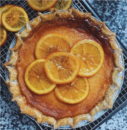  ?? NEW PIE COMPANY PHOTOS ?? Orange honey pie with cardamom crust and candied oranges. “Pies are really close to my heart,” says Shiela Labao, right, baker and owner of Toronto’s New Pie Company.