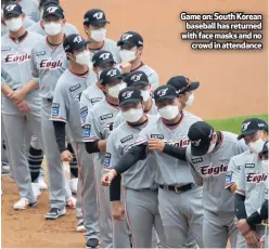  ??  ?? Game on: South Korean
baseball has returned with face masks and no
crowd in attendance
