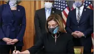  ?? ALEX BRANDON - THE ASSOCIATED PRESS ?? House Speaker Nancy Pelosi of Calif. signs the article of impeachmen­t against President Donald Trump in an engrossmen­t ceremony before transmissi­on to the Senate for trial on Capitol Hill, in Washington, Wednesday, Jan. 13, 2021.