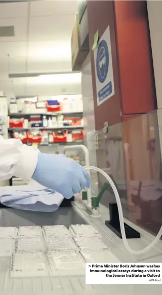  ?? WPA Pool ?? Prime Minister Boris Johnson washes immunologi­cal assays during a visit to the Jenner Institute in Oxford