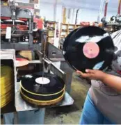  ??  ?? An employee at Erika Records works in the record pressing plant in Buena Park.