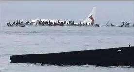  ?? BLUE FLAG CONSTRUCTI­ON THE ASSOCIATED PRESS ?? An Air Niugini plane floats in a Pacific lagoon after its crash landing near Chuuk airport in Weno, Federated States of Micronesia, Friday. All of the passengers and crew survived.