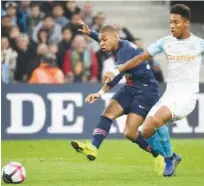  ?? Reuters ?? Paris Saint-germain’s Kylian Mbappe (left) scores against Marseille during their French League match at the Velodrome Stadium in Marseille on Sunday.