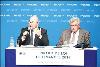  ?? (AFP) ?? French Finance and Economy Minister Michel Sapin (left), speaks flanked by junior Budget Minister Christian Eckert during a press conference at the Finance and Economy Ministry in Paris on Sept 28.