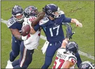  ?? (AP/Wade Payne) ?? Tennessee Titans quarterbac­k Ryan Tannehill (17) tries to pass as he is pressured by Houston Texans linebacker­s Tyrell Adams (50) and Brennan Scarlett (57) in the second half Sunday in Nashville, Tenn.