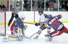  ?? CLIFFORD SKARSTEDT/EXAMINER ?? Lakefield Chiefs' Aaron Vatcher fires the puck at Port Hope Panthers goalie Eric Jackson while pursued by Nathan Snoek during Game 5 of PJHL Schmalz Cup Quarter-Final on Thursday night at the Lakefield-Smith Community Centre in Lakefield. The Chiefs...