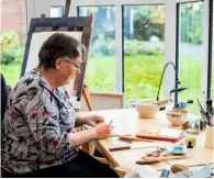  ??  ?? Sitting in her light-filled conservato­ry studio overlookin­g the garden, Lincolnshi­re illuminato­r Toni Watts makes sketches for the illustrati­ons on her latest manuscript.