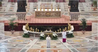  ?? (Vatican Media/Reuters) ?? POPE FRANCIS reads his ‘Urbi et Orbi’ (‘To the City and the World’) message in St. Peter’s Basilica with no public participat­ion due to the outbreak of the coronaviru­s on Easter Sunday at the Vatican yesterday.