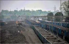  ?? PTI ?? Labourers carry coal onto goods train at Ashoka Coal Mines in Peeparwar, , about 70 Kms from Ranchi
