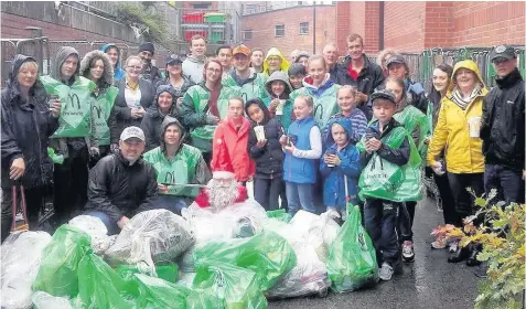  ?? McDonald’s staff and volunteers from Ormskirk Churches Together at work on their annual clean-up ??