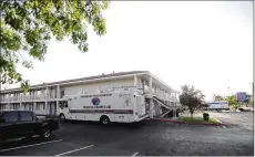  ?? ADOLPHE PIERRE-LOUIS/ ALBUQUERQU­E JOURNAL ?? An Albuquerqu­e Police Department Mobile Crime Lab is seen at the Motel 6 where Lynne Russell and Chuck de Caro stayed in 2015. They had no idea local police had been called to the motel hundreds of times in the previous six years.