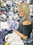  ?? AP ?? HELPING HAND: A volunteer helps sort donated clothing at the George R. Brown Convention Center earlier this week in Houston.