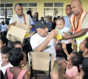  ?? Photo: Waisea Nasokia ?? Prime Minister Voreqe Bainimaram­a with children at the evacuation centre at Tavua College on April 12, 2018.