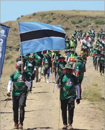  ?? PIC: MOMPS RANKGATE ?? Flying high: Botswana flag bearer, Ace Maghosa (left) traversed the 116km trek through the mountains of Lesotho during the King Moshoeshoe hike