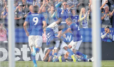  ??  ?? Leicester City’s James Maddison, bottom, celebrates his winner with team mates.