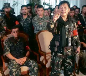 ??  ?? 10 YEARS AGO Army Captains Milo Maestrecam­po (center) and Gerardo Gambala (seated) hold press conference in Makati City.