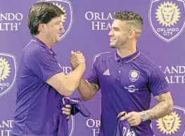  ?? RED HUBER/STAFF PHOTOGRAPH­ER ?? Dom Dwyer, being welcomed by Orlando City CEO Alex Leitão, has raised the energy level.