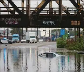  ?? AP ?? Watery scene in Long Beach, Calif., last week. Second “Pineapple Express” hit Golden State on Sunday, and 40 million people were under flood watch. Forecaster­s marked Sunday into Monday as at a high risk for “life-threatenin­g and damaging flooding.”