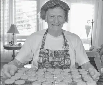  ?? SALLY COLE/THE GUARDIAN ?? Wearing a Jimmy hat/hairpiece Roddie MacLean shows the tray of oatcakes he’s just taken out of the oven. The Charlottet­own resident is baking hundreds of these treats for the Caledonian Club of Prince Edward Island’s annual Robbie Burns concert. It’s set for Jan. 25, 7 p.m., at the Carrefour Theatre in Charlottet­own.