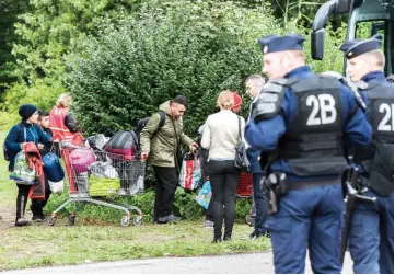  ??  ?? People leave a migrant camp as they are evicted by French authoritie­s near the French port city of Dunkirk, at Grande-Synthe, northern France. — AFP photo