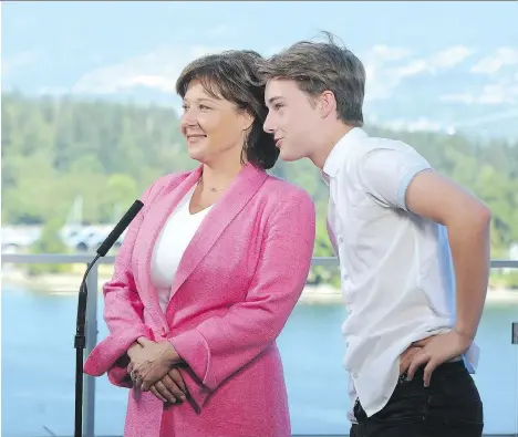  ?? NICK PROCAYLO ?? Former premier Christy Clark, with her son Hamish, talks to reporters on Monday about her resignatio­n as Liberal leader.