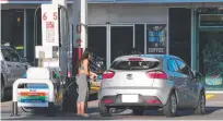  ??  ?? A motorist fuels up at Mobil Petrol station at Hope Island.