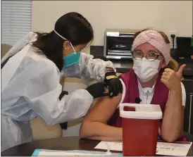  ?? SUBMITTED PHOTO ?? Irina Lucas, RN, Home Care Case Manager receives her vaccine from Kayly Sie, PharmD, President and Co-Founder of Wellness Pharmacy Services.