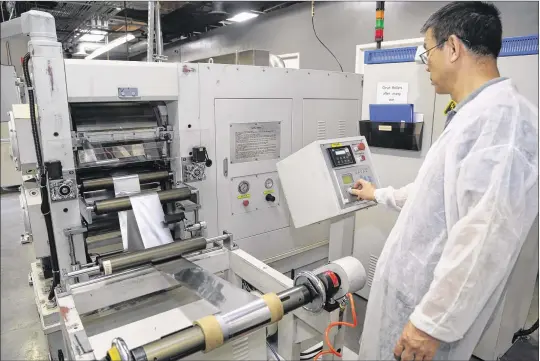  ?? PHOTOS BY DAVID BROOKS / SAN DIEGO UNION-TRIBUNE ?? A technician monitors battery production at American Lithium Energy’s facility in Carlsbad, Calif. The company makes lithium-ion batteries mostly for the military.