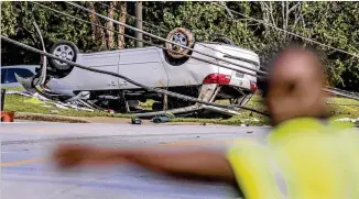  ?? JOHN SPINK / JSPINK@AJC.COM ?? Power was restored at Georgia Piedmont Technical College after a car crash caused an outage at the DeKalb County school. Student David Jefferson said he saw the driver “dodging traffic” minutes before the crash. The car hit a curb, went into the air...