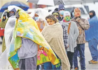  ?? DAVID J. PHILLIP/ASSOCIATED PRESS FILE PHOTO ?? People wait more than an hour in freezing rain to fill propane tanks Feb. 17 in Houston. The Texas cold wave caused close to 150 deaths and at least $20 billion in damages.