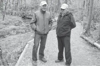  ?? DAVID JALA/CAPE BRETON POST ?? Community volunteers David Gabriel and Joe Dennis are shown discussing possible flood mitigation measures and their potential effects on the Baille Ard Nature Trails in this file photo from last June. The south end Sydney trail system is just one of many options for CBRM residents looking to enjoy a more active lifestyle. The municipali­ty’s Active Transporta­tion Plan calls for more trails, walking paths and bicycling lanes across the CBRM.