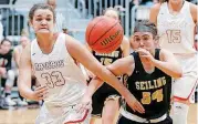  ?? [PHOTO BY BRYAN TERRY, THE OKLAHOMAN] ?? Mustang’s Jaycee Freshour, left, and Seiling’s Harley Waldrep race for a loose ball during the Mustang Holiday Classic on Friday.