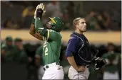  ?? JED JACOBSOHN — THE ASSOCIATED PRESS ?? The A’s Starling Marte, left, points to the sky after hitting a solo home run in front of Seattle Mariners’ Tom Murphy, right, during the fourth inning in Oakland on Tuesday.