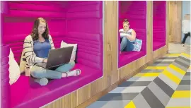  ?? DYER BROWN ARCHITECTS VIA AP ?? Jen Taylor and Michelle Bristol of Dyer Brown architectu­ral firm sit in workspaces they designed for the Boston offices of Criteo, a tech company. The comfy, soundinsul­ated cubbies are an unplugged zone intended for heads-down work such as writing or a...
