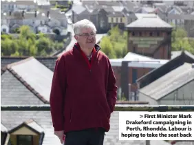  ??  ?? > First Minister Mark Drakeford campaignin­g in Porth, Rhondda. Labour is hoping to take the seat back