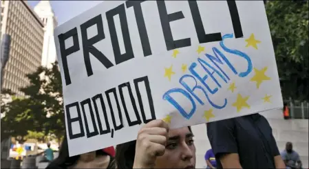  ?? PHOTO/DAMIAN DOVARGANES ?? In this Sept. 1 file photo, a woman joins a rally in support of the Deferred Action for Childhood Arrivals outside the Edward Roybal Federal Building in downtown Los Angeles. AP