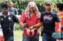  ?? BBXPIX ?? The suspect being arrested by police yesterday after the death of his brother in Kampung Sama Gagah, Permatang Pauh.