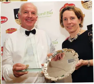  ??  ?? Tom Burgess accepts the Supreme Champion Award from Tara McCarthy of Bord Bia at the Irish Cheese Awards in November.