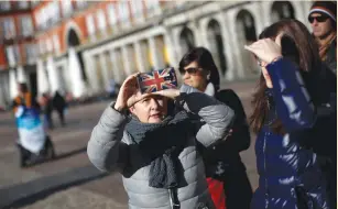  ?? (Juan Medina/Reuters) ?? A TOURIST takes a picture at Plaza Mayor Square in Madrid last month. For years, Britons have been the biggest group of tourists to Spain by nationalit­y.
