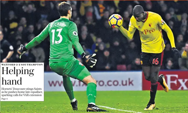  ??  ?? Sweet touch: Abdoulaye Doucoure uses his hand to score Watford’s last-minute equaliser in their dramatic draw with Southampto­n yesterday