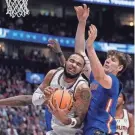  ?? JOHN BAZEMORE/AP ?? Auburn forward Johni Broome (4) pullls down a rebound against Florida forward Alex Condon (21) on Sunday in Nashville, Tenn.