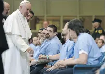  ?? DAVID MAIALETTI/ PHILADELPH­IA INQUIRER ?? Pope Francis greets inmates at Curran- Fromhold Correction­al Facility in Philadelph­ia on Sunday.