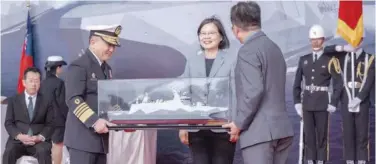  ?? Associated Press ?? ↑
Taiwan’s President Tsai Ing-wen receives a model showing the newly commission­ed navy ships in the port of Suao on Tuesday.