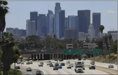  ?? (AP PHOTO/MARK J TERRILL ?? In this May 19, file photo, traffic moves along Interstate 10 as downtown Los Angeles is seen in the background.