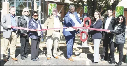  ?? Brodie Johnson • Times-Herald ?? East Arkansas Community College unveild its new electric vehicle charging station on campus on Thursday as a crowd gathered to test drive multiple new all electric vehicles. President and CEO of Today’s Power Inc., Derek Dyson assists EACC President Dr. Cathie Cline in cutting the ribbon during the ceremony on Thursday.