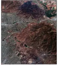  ?? (AP/Maxar Technologi­es) ?? This satellite image provided by Maxar Technologi­es on Wednesday, shows the burned mountains from the Blue Ridge Fire near homes in Yorba Linda, Calif.