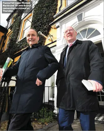  ??  ?? Fianna Fáil leader Micheál Martin and TD John Brassil canvassing in Listowel on Thursday.