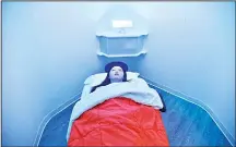  ??  ?? Laura Li prepares to take a nap in YeloSpa, in New York on May 1, where New Yorkers can pay for a cabin to take a nap and recharge energy without
having to return to their homes. (AFP)